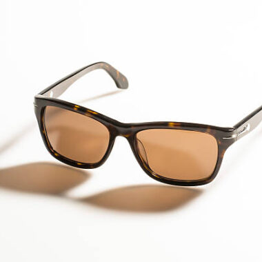 Sunglasses on white background with long shadow