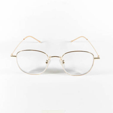 Gold frame spectacles glasses in a white isolated background