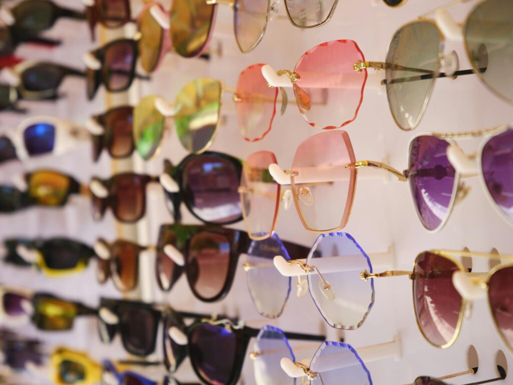 A vibrant array of stylish sunglasses showcased on a display stand.