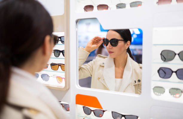 Woman trying on eyeglasses at optometrists